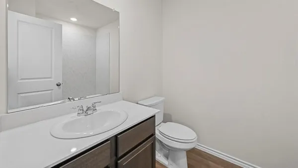 a bathroom with a sink toilet and a mirror