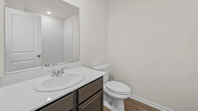 a bathroom with a sink toilet and a mirror