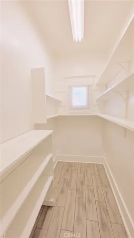 a view of a room with wooden floor and brick walls