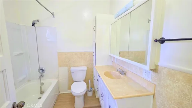a bathroom with a sink a toilet and bathtub