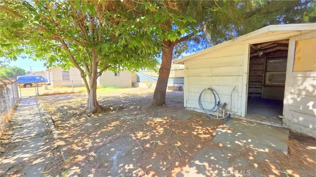 a view of a grey house with a yard