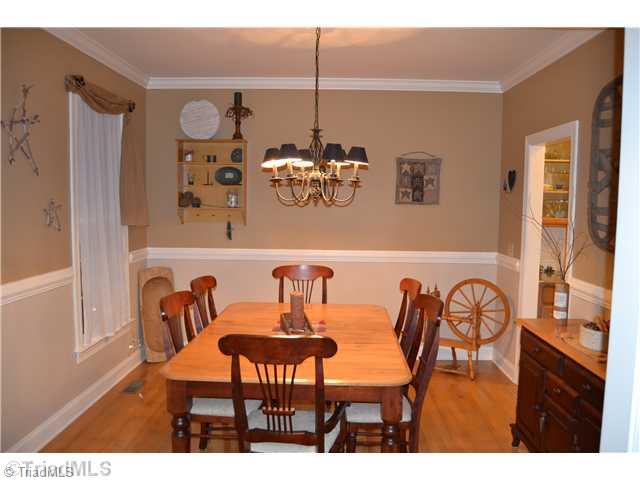 7497 Bethel View Court Oak Ridge, NC 27310 - Photo 3 of 16 Dining Room. WOOD FLOORS AND CHAIR RAIL MOLDING
