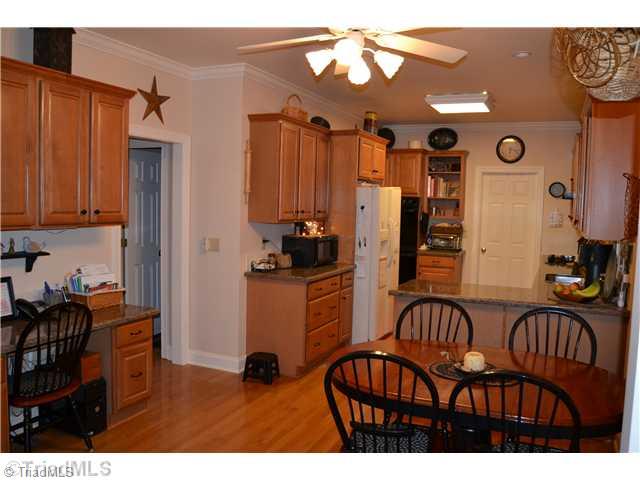 7497 Bethel View Court Oak Ridge, NC 27310 - Photo 8 of 16 Kitchen. WOOD FLOORS AND BUILT IN WORKSTATION