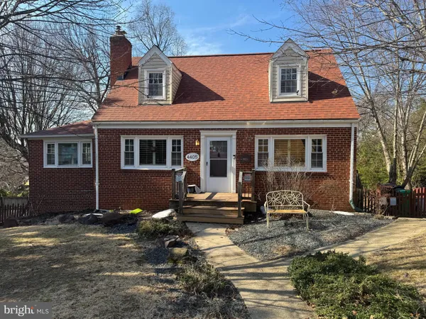 a front view of a house with sitting area
