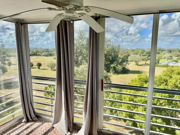 a view of a glass door with a glass windows and next to a yard