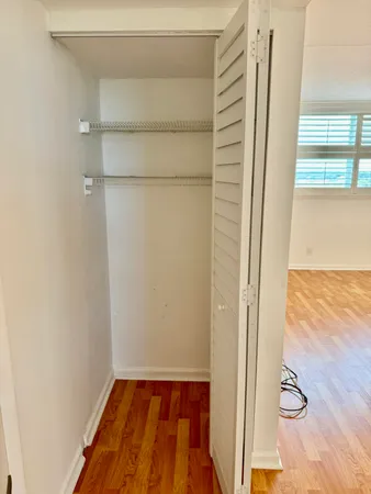 a view of walk in closet with empty racks