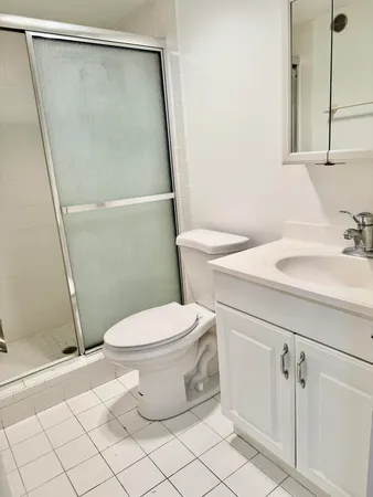 a white toilet sitting next to a bathroom sink