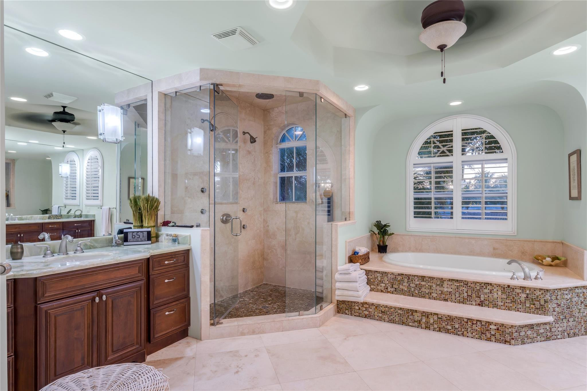 3489 Northeast 30th Avenue Lighthouse Point, FL 33064 - Photo 29 of 42 a spacious bathroom with a tub sink and mirror