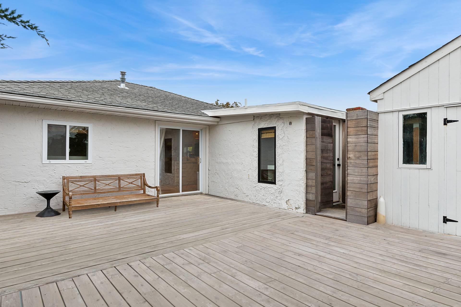 203 Shore Road Amagansett, NY 11930 - Photo 11 of 20 a front view of a house with a patio