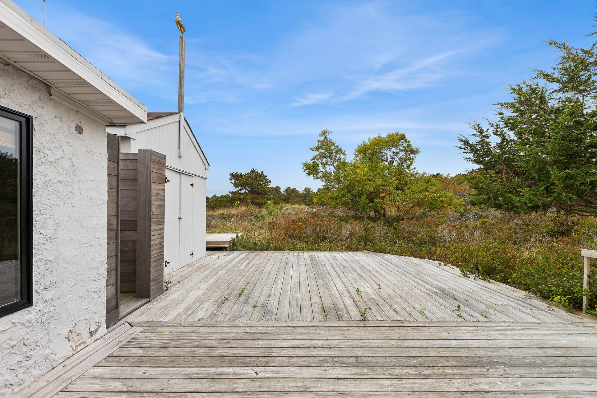 203 Shore Road Amagansett, NY 11930 - Photo 12 of 20 a view of a house with a wooden fence