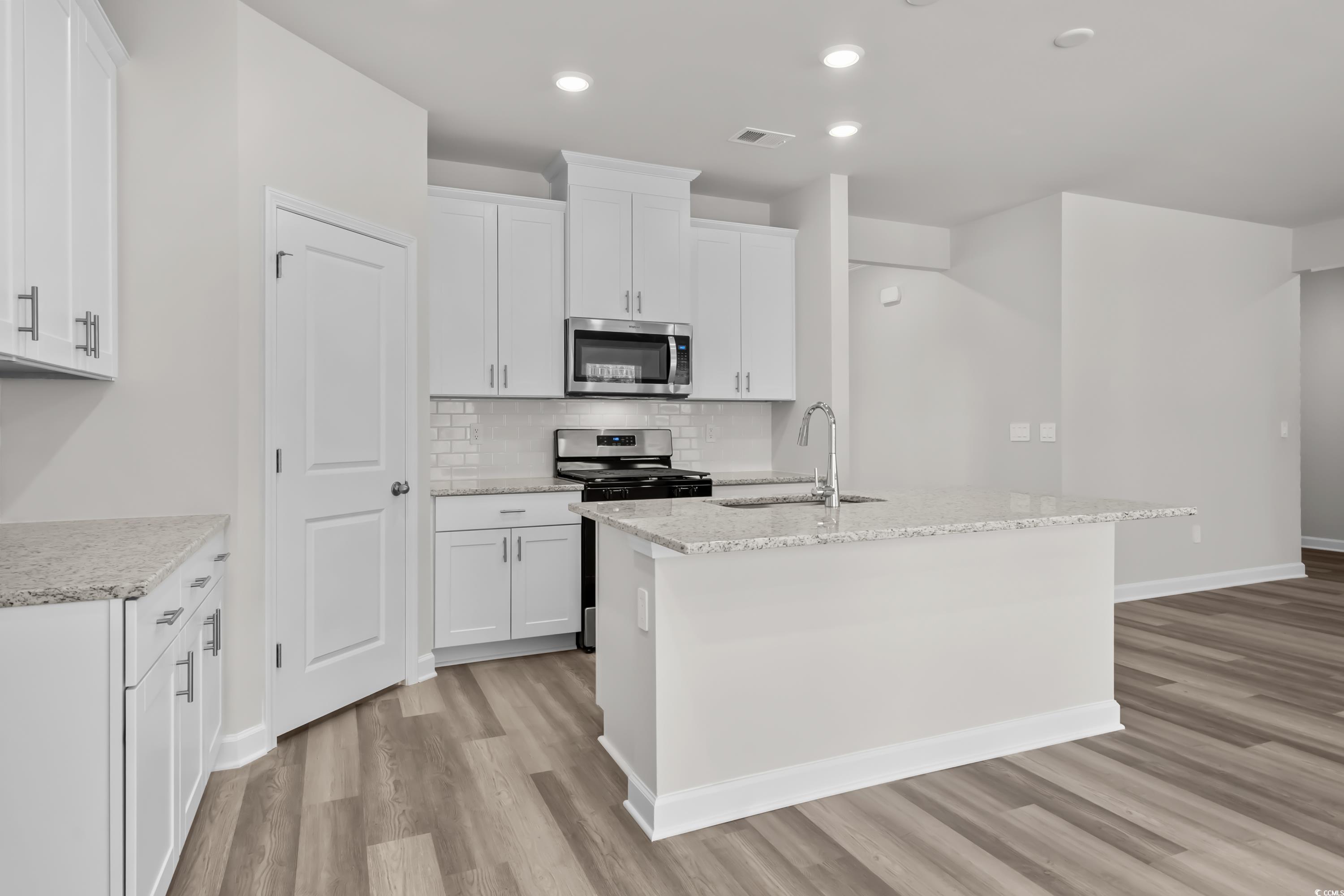 2052 Copper Crk Loop Longs, SC 29568 - Photo 11 of 40 Kitchen featuring a sink, tasteful backsplash, sta