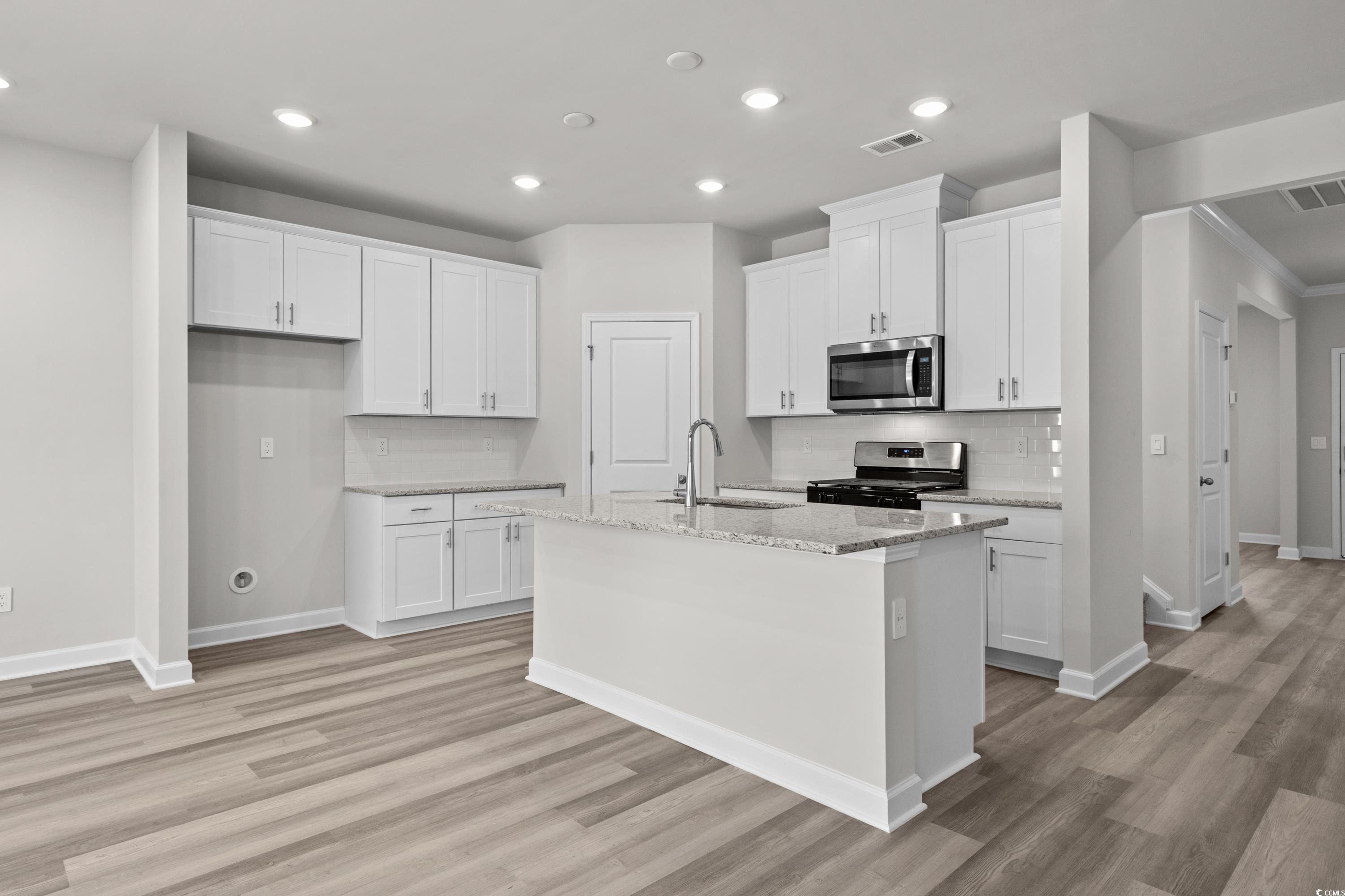 2052 Copper Crk Loop Longs, SC 29568 - Photo 12 of 40 Kitchen with visible vents, light wood finished fl
