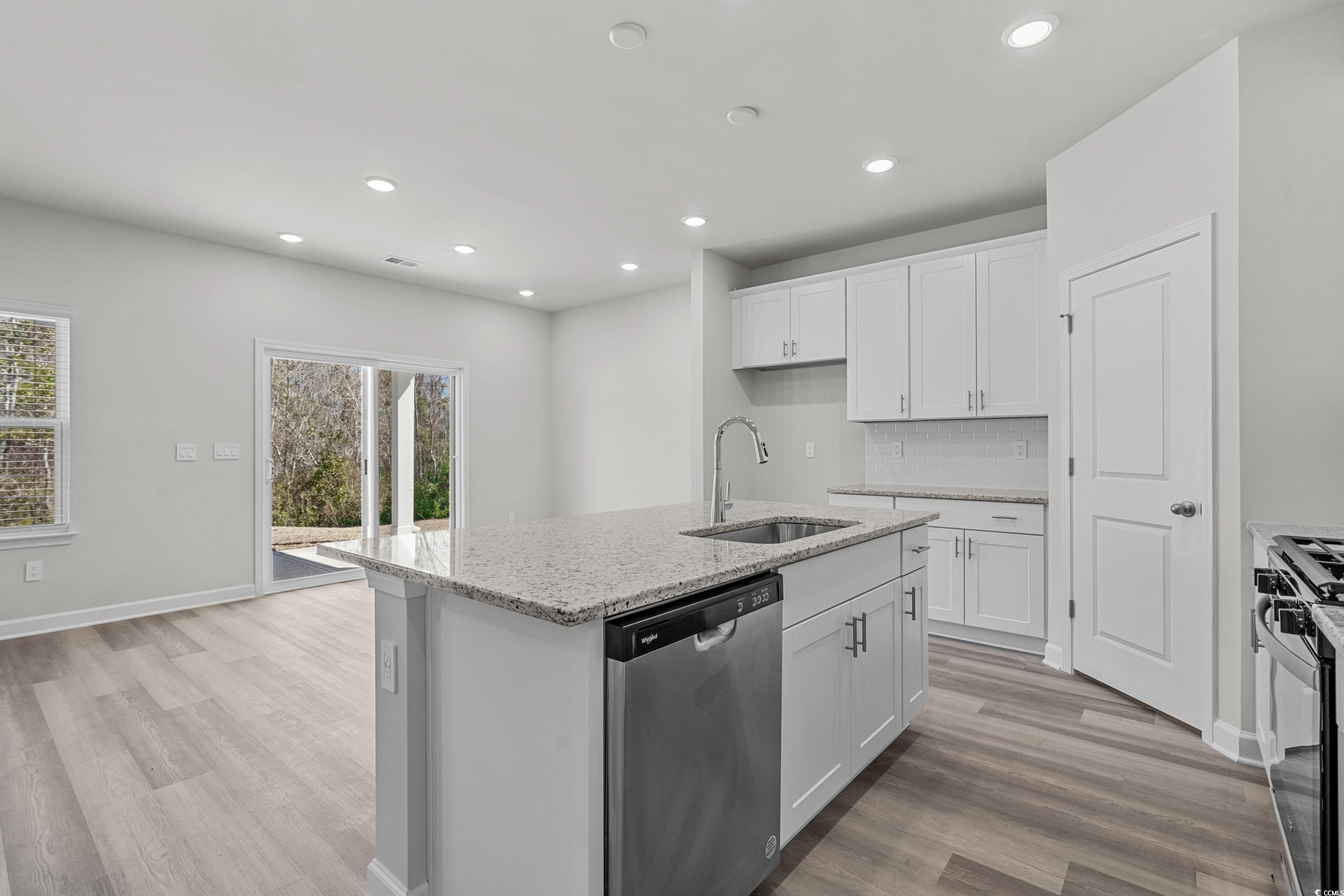 2052 Copper Crk Loop Longs, SC 29568 - Photo 13 of 40 Kitchen with tasteful backsplash, a sink, light wo
