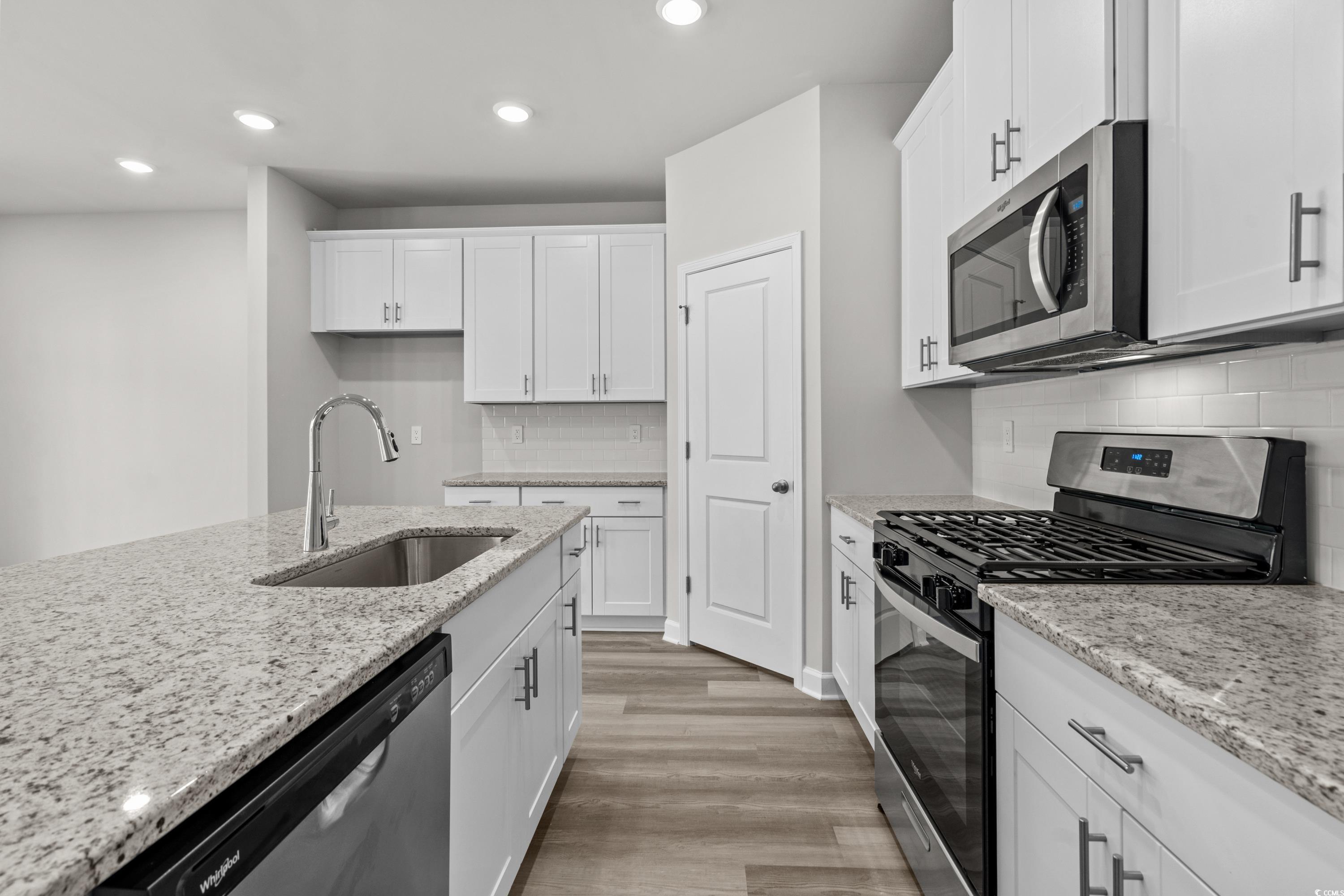 2052 Copper Crk Loop Longs, SC 29568 - Photo 14 of 40 Kitchen featuring white cabinets, a sink, stainles