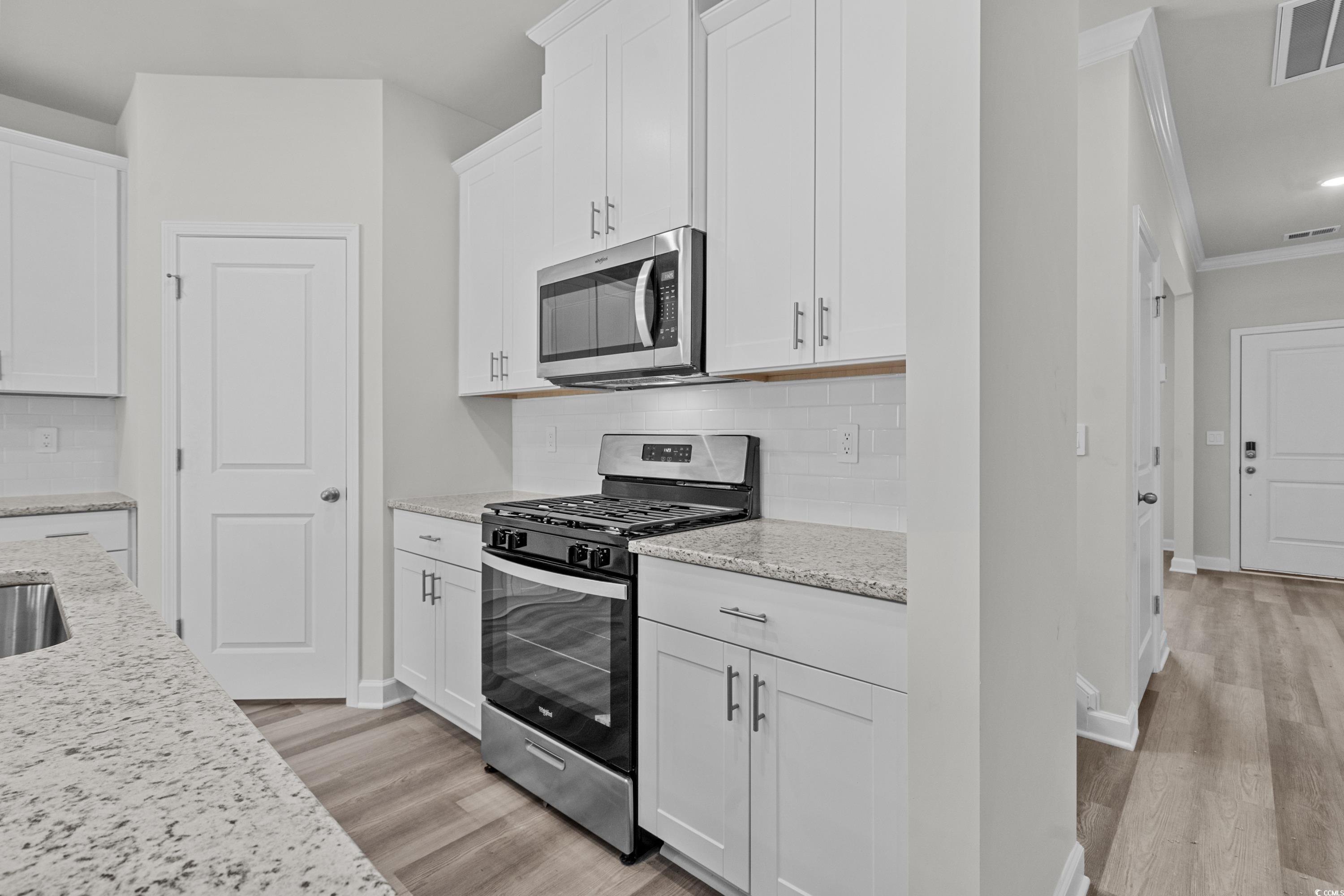 2052 Copper Crk Loop Longs, SC 29568 - Photo 15 of 40 Kitchen with visible vents, crown molding, applian