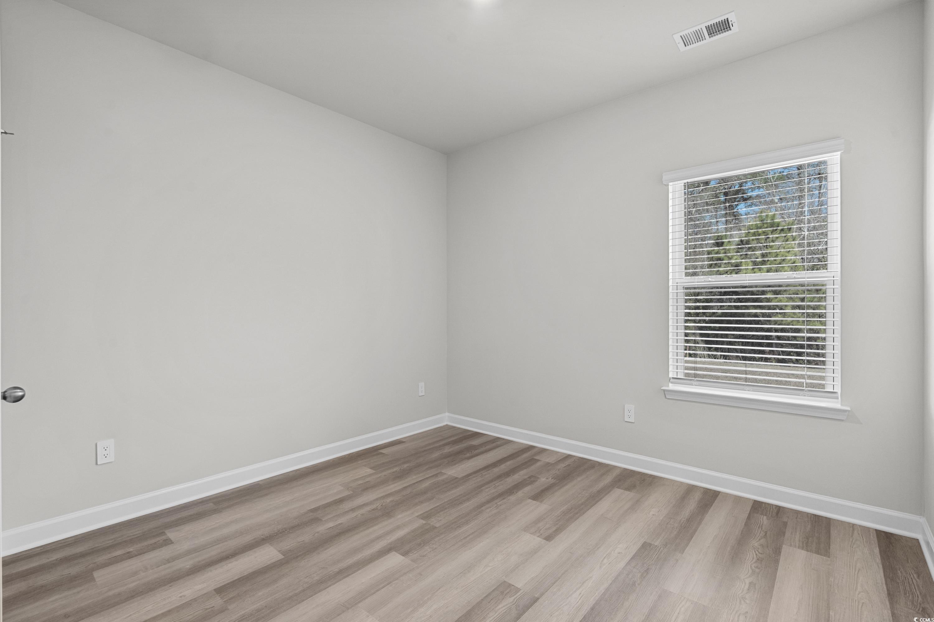 2052 Copper Crk Loop Longs, SC 29568 - Photo 34 of 40 Empty room with baseboards, visible vents, and woo