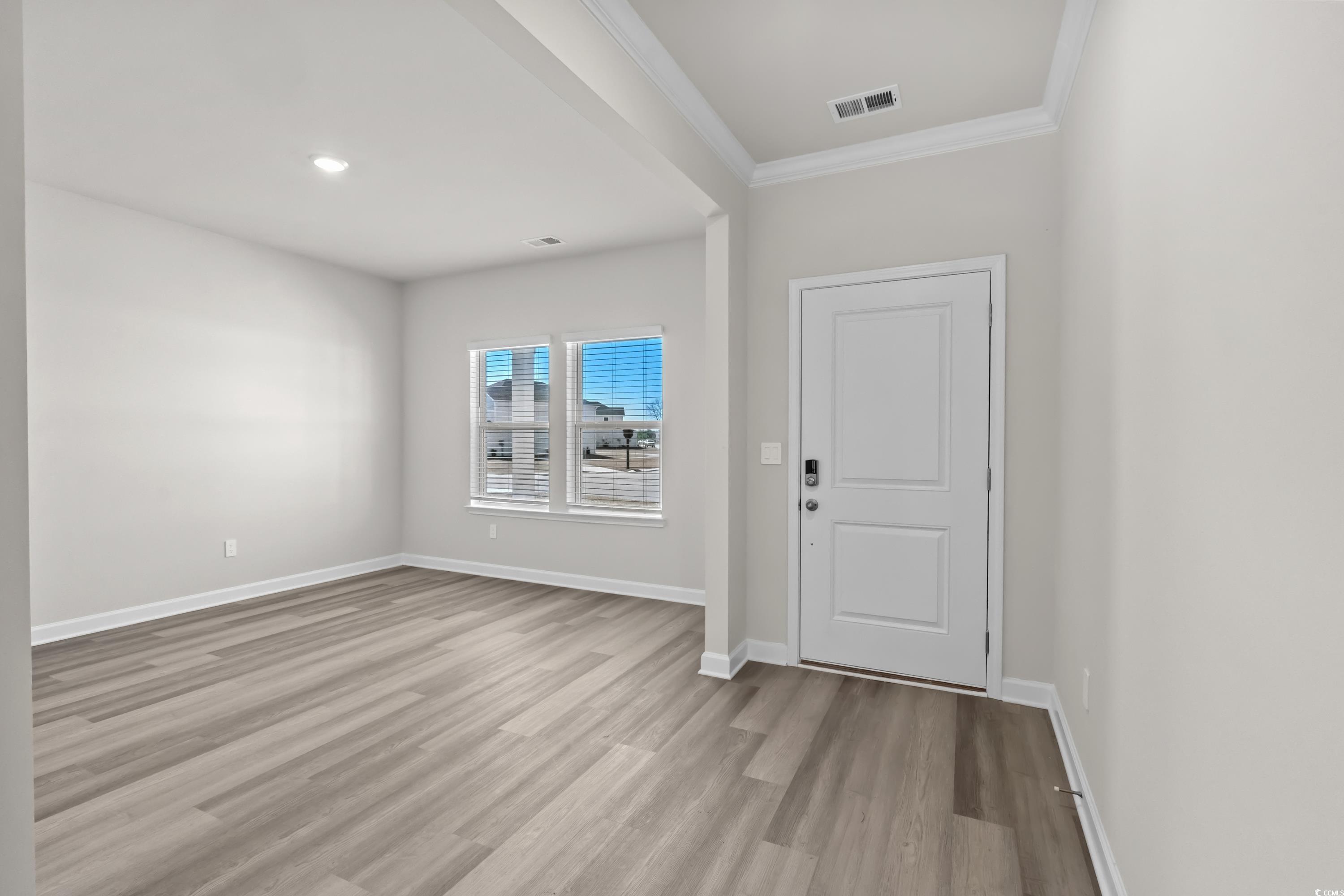 2052 Copper Crk Loop Longs, SC 29568 - Photo 4 of 40 Foyer featuring wood finished floors, crown moldin