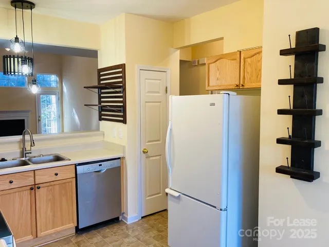 a white refrigerator freezer sitting in a kitchen