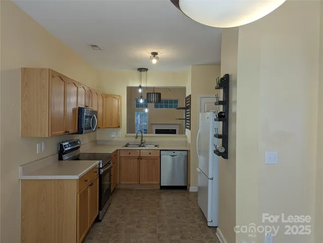 a kitchen with a sink cabinets and stainless steel appliances