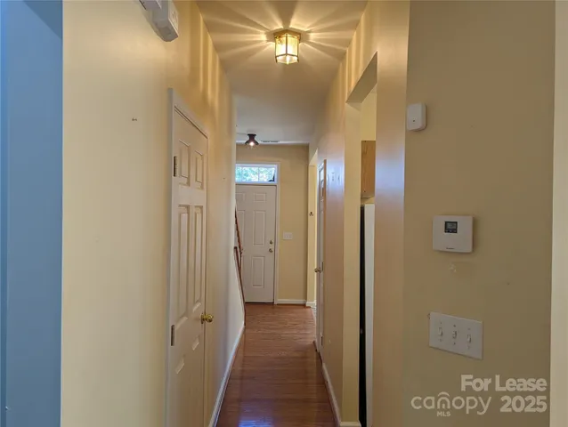 a view of a hallway with wooden floor