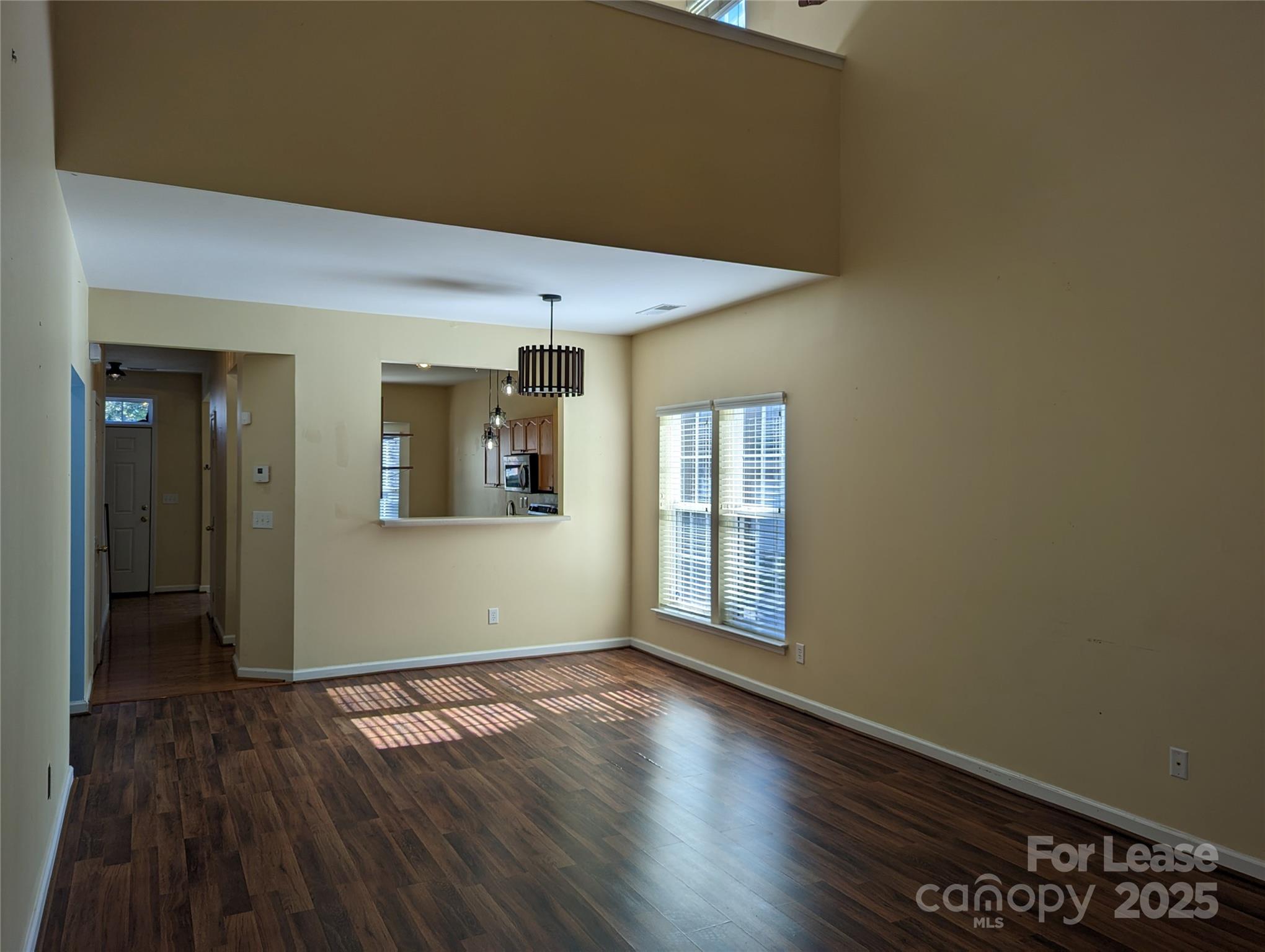 7920 Mariners Pointe Circle Denver, NC 28037 - Photo 7 of 21 an empty room with wooden floor and windows