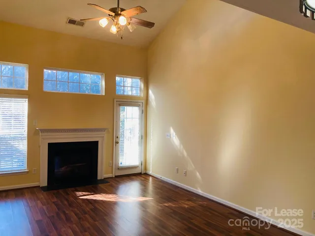 a view of a livingroom with a fireplace and wooden floor