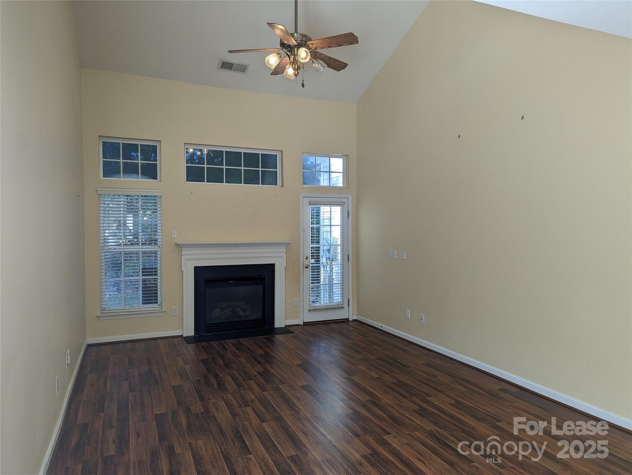 7920 Mariners Pointe Circle Denver, NC 28037 - Photo 9 of 21 a view of a livingroom with a fireplace a ceiling fan and brick wall