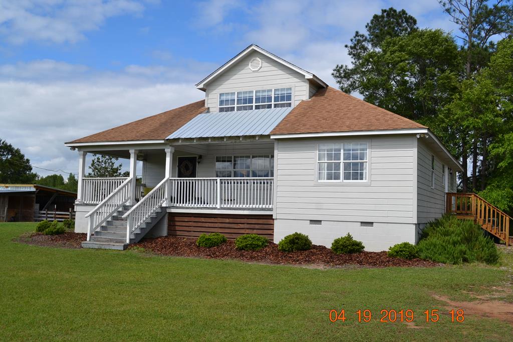 175 Kirkland Road Seale, AL 36875 - Photo 1 of 37 a front view of a house with a garden and yard