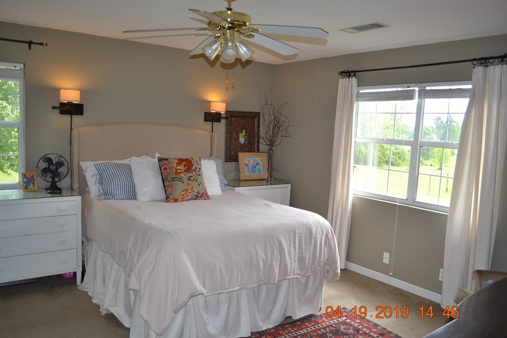 175 Kirkland Road Seale, AL 36875 - Photo 13 of 37 a bedroom with a bed and a chandelier