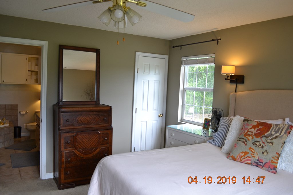 175 Kirkland Road Seale, AL 36875 - Photo 14 of 37 a bedroom with a bed and a chandelier