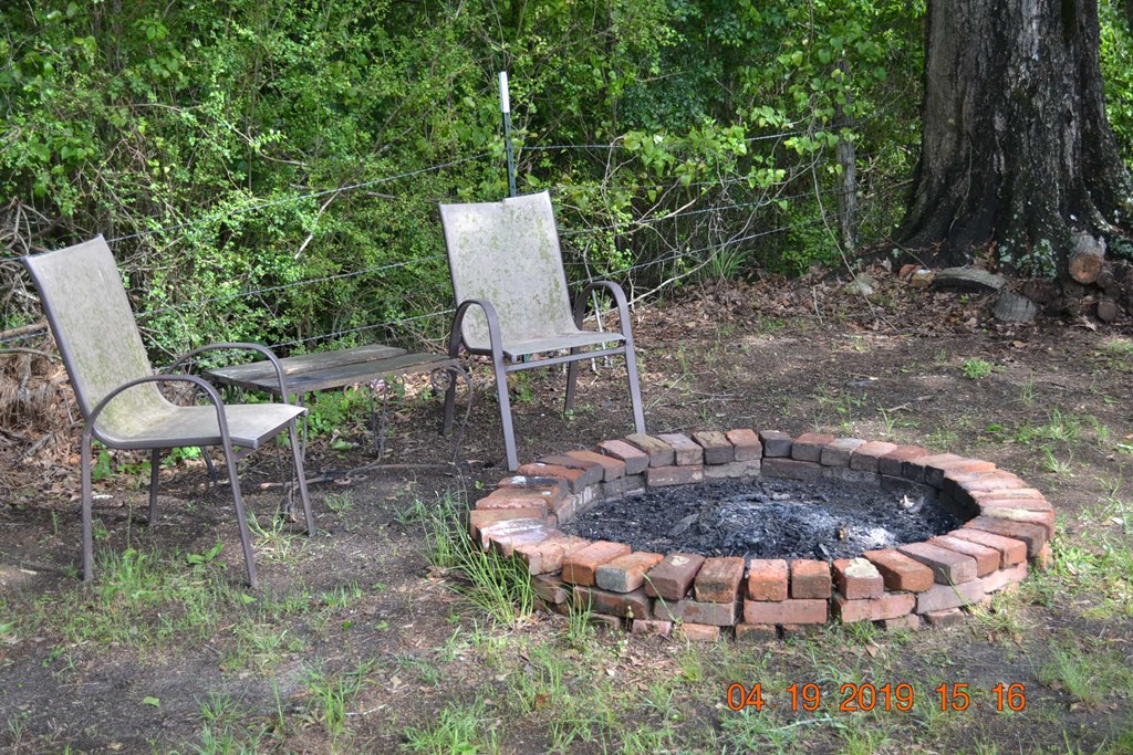 175 Kirkland Road Seale, AL 36875 - Photo 29 of 37 a table and chairs in a backyard