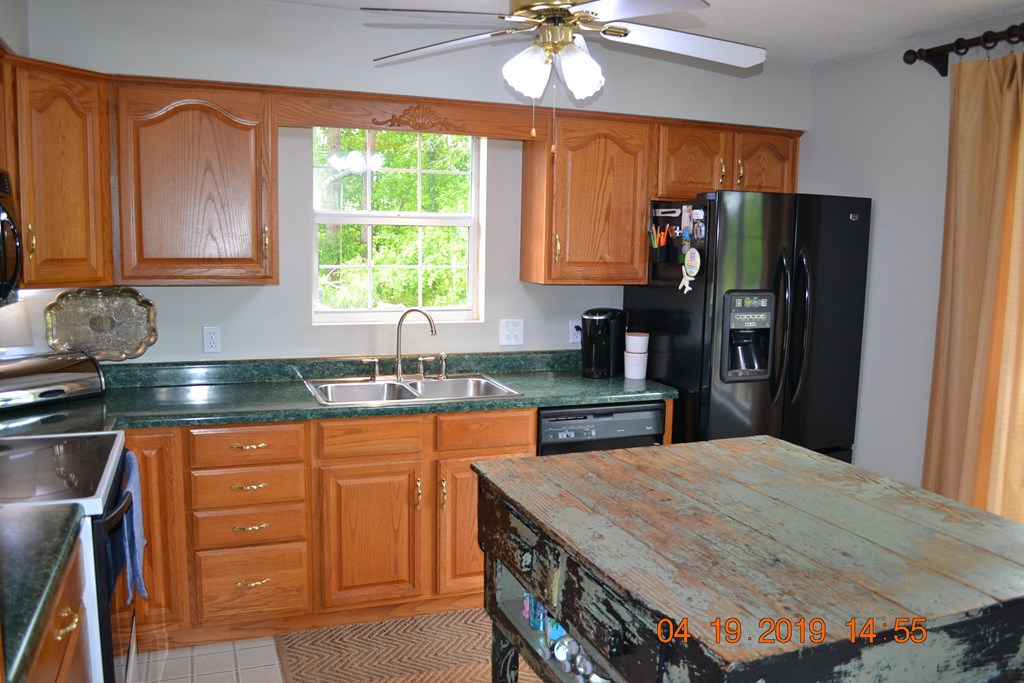 175 Kirkland Road Seale, AL 36875 - Photo 3 of 37 a kitchen with granite countertop a sink stainless steel appliances and cabinets