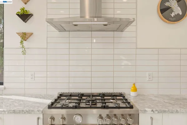 a view of a kitchen with a sink and potted plants