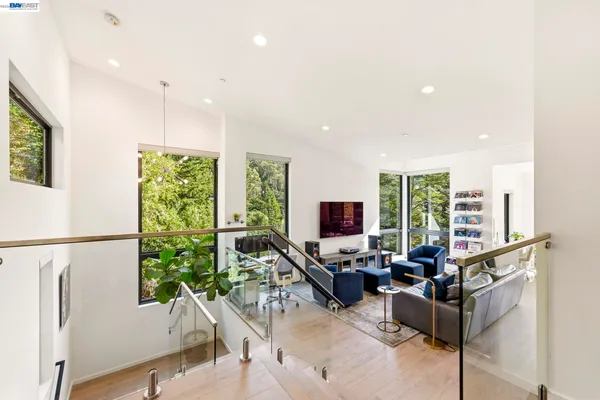 a living room with furniture large window and flat screen tv