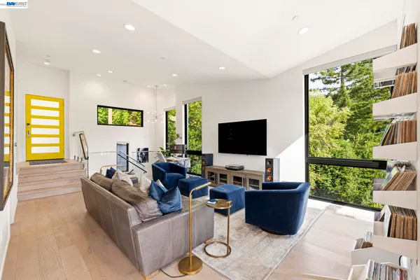 a living room with furniture and a floor to ceiling window