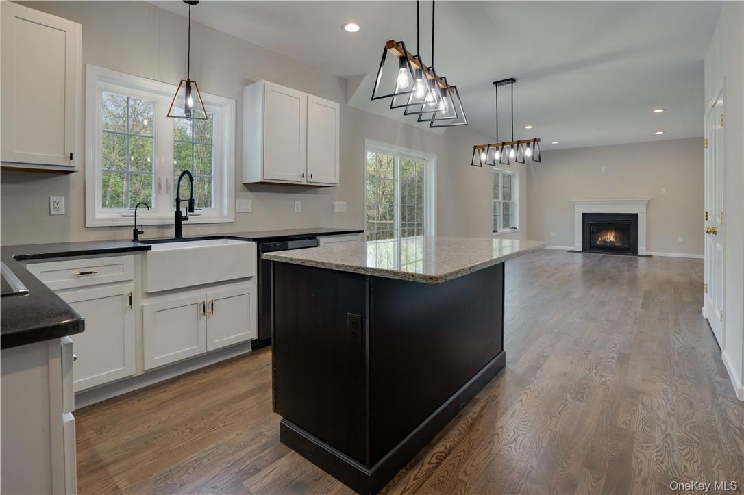 991 Freedom Road Pleasant Valley, NY 12569 - Photo 7 of 23 a kitchen with kitchen island granite countertop a sink cabinets and wooden floor