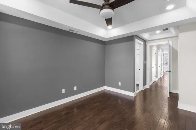 a view of an empty room with wooden floor