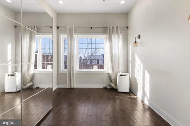 a view of room with window and wooden floor