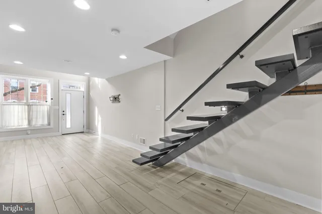 a view of an entryway with wooden floor
