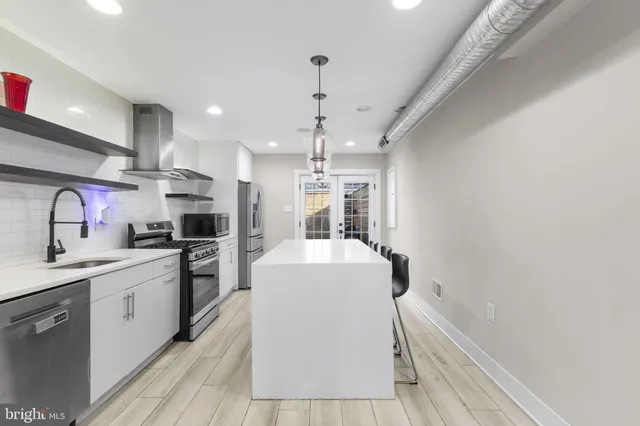 a kitchen with a sink stove and refrigerator