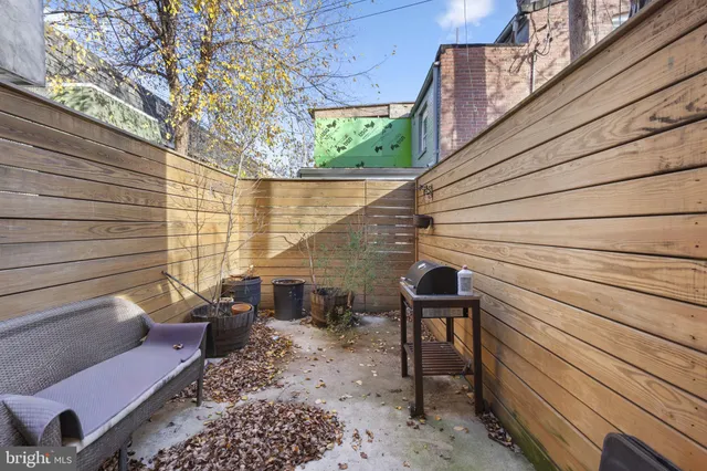 a backyard of a house with outdoor seating