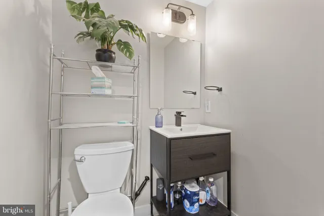 a bathroom with a toilet sink and mirror