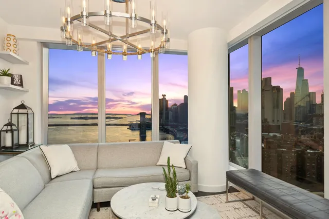 a living room with fireplace furniture and a large window