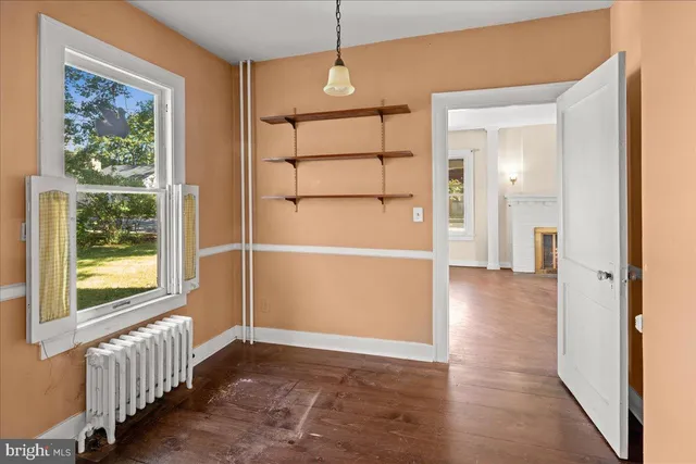 a view of a room with wooden floor and windows