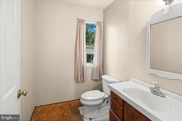a bathroom with a sink toilet and vanity