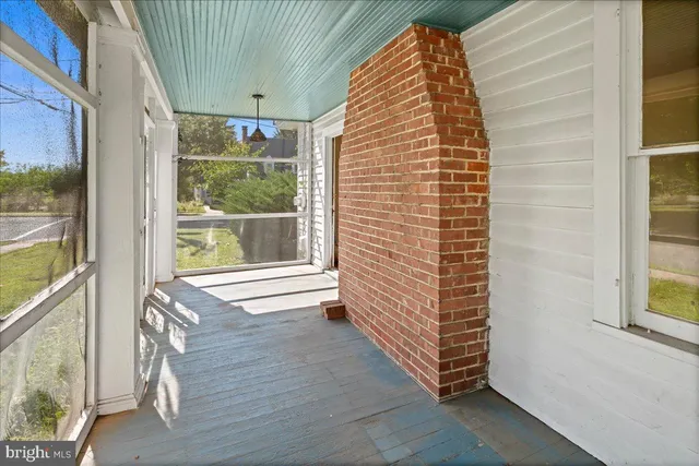 a view of a room with wooden floor and windows