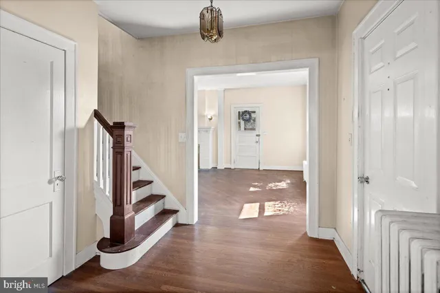 a view of a hallway view with wooden floor and staircase