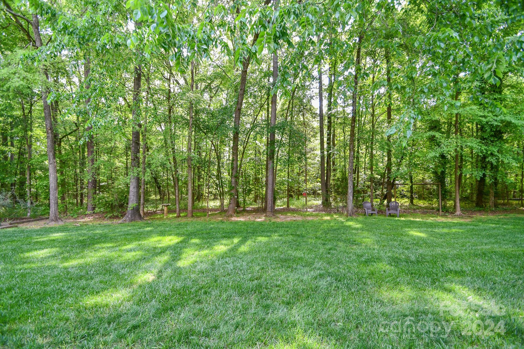 9509 Marvin School Road Marvin, NC 28173 - Photo 7 of 12 a backyard of a house with lots of green space