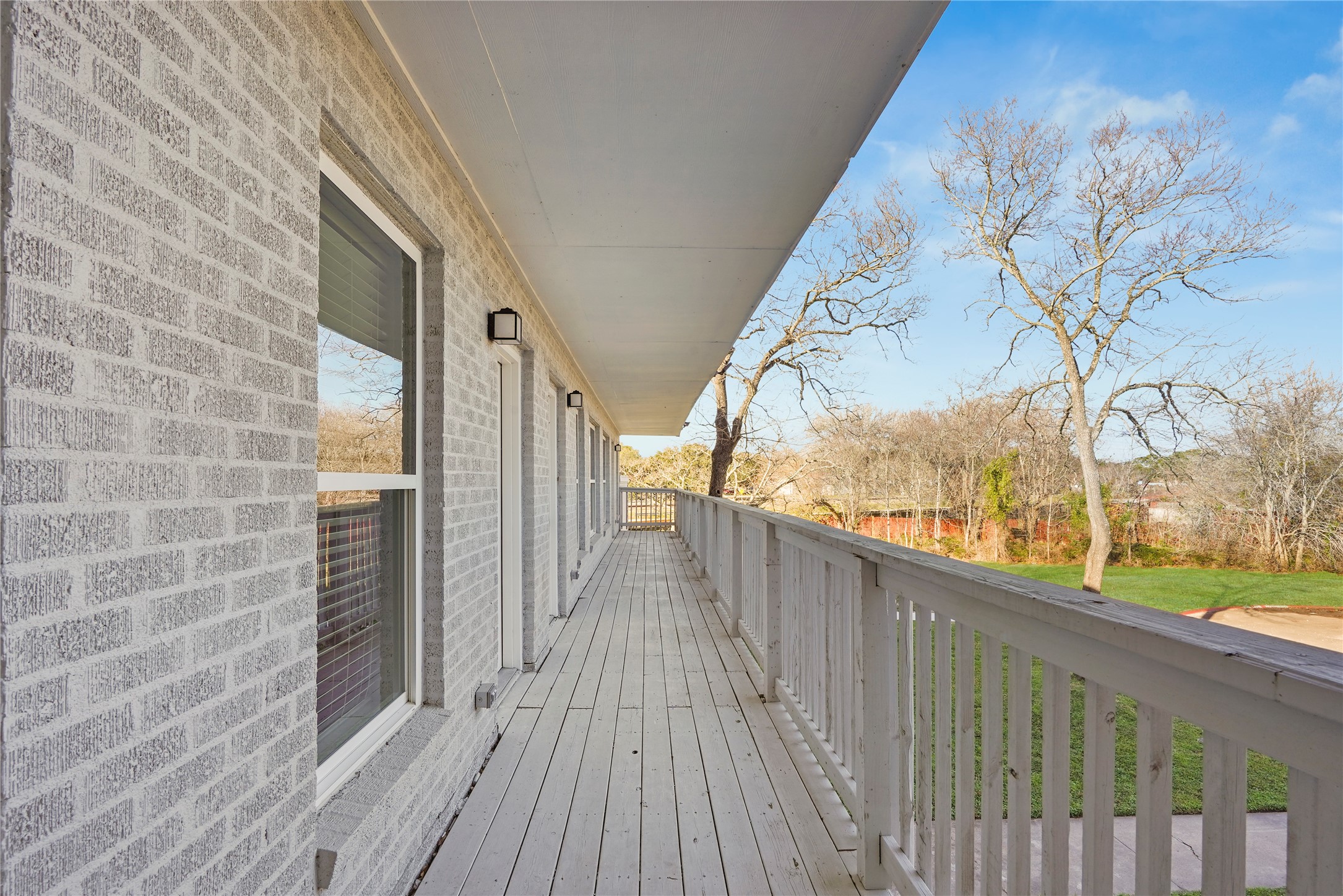 1803 Oak Street, Unit 9 La Marque, TX 77568 - Photo 2 of 12 a view of a balcony with wooden floor and fence