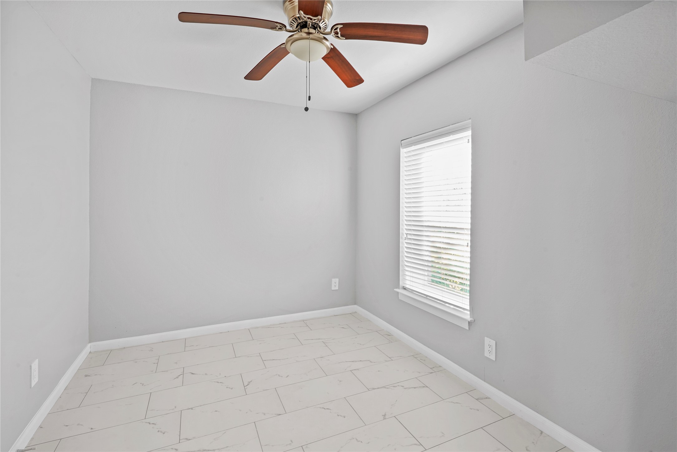 1803 Oak Street, Unit 9 La Marque, TX 77568 - Photo 4 of 12 an empty room with windows and fan
